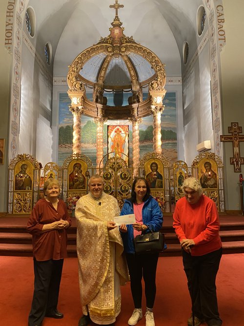 The $1,000 GCU check presented at St. John the Baptist